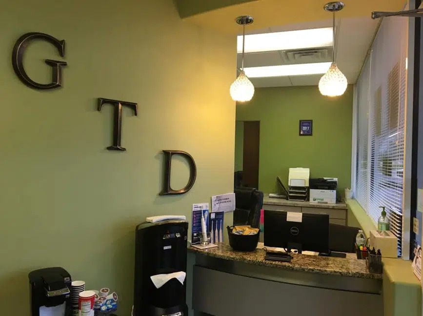 Front desk with GTD letters at the Gentle Touch Dentistry office in Richardson, TX